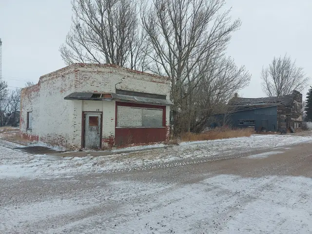 Abandoned brick storefront on a snowy street